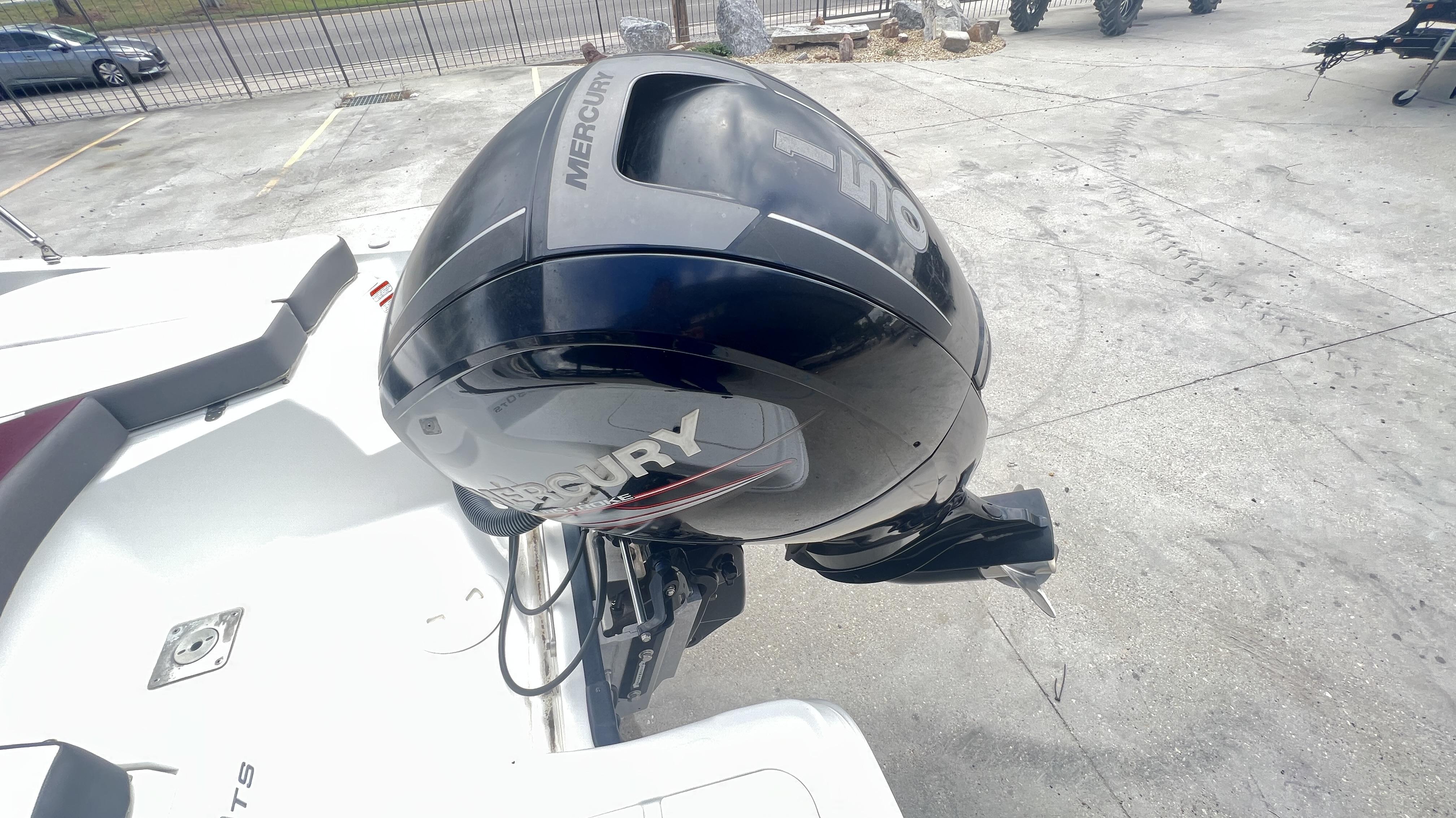 Slide: The Image of 2018 Tahoe 550 TS boat with Mercury outboard motor in a parking area. - 12