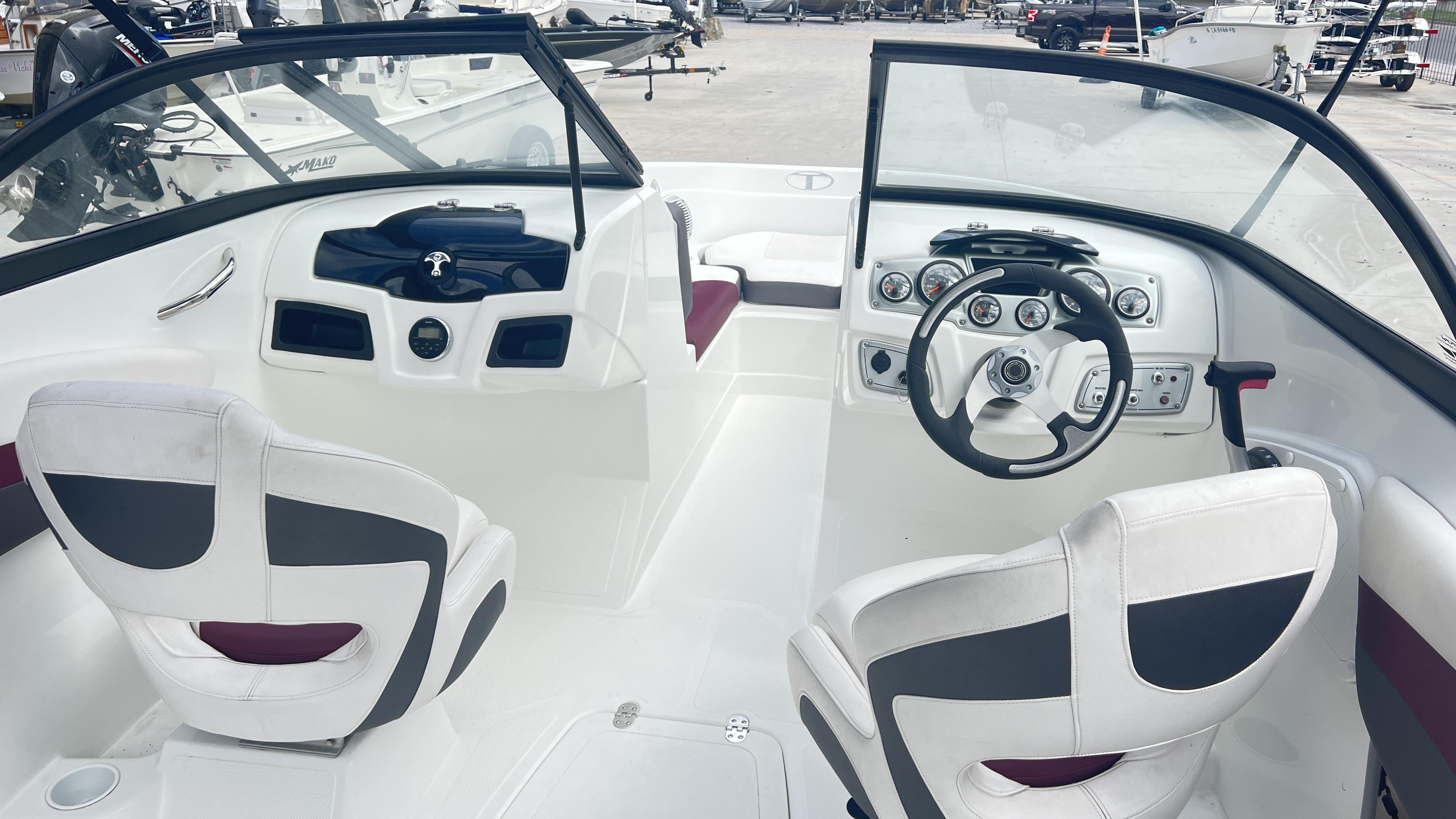 Slide: The Image of Interior of 2018 Tahoe 550 TS boat with steering wheel and seating. - 7