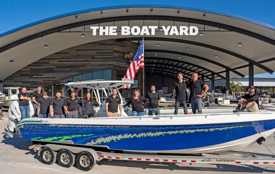 Slide: The Image of Group of people standing on a 2021 Tahoe T16 boat at The Boat Yard. - 14