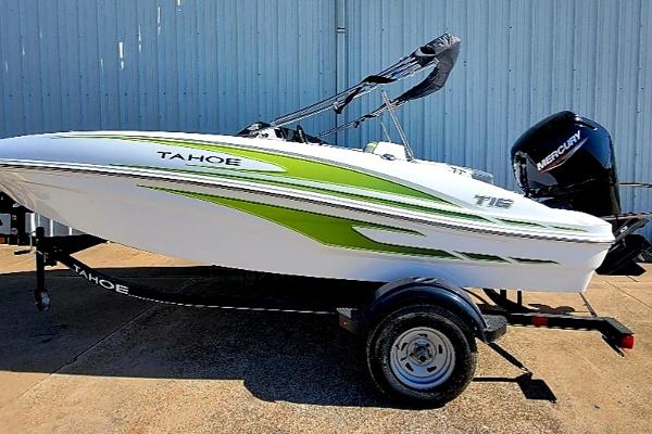 Slide: The Image of 2024 Tahoe T16 boat with green accents on a trailer. - 0