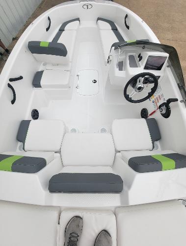 Slide: The Image of 2024 Tahoe T16 boat interior with seating and steering console. - 2