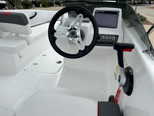 Slide: The Image of 2024 Tahoe T16 boat cockpit with steering wheel and control panel. - 2