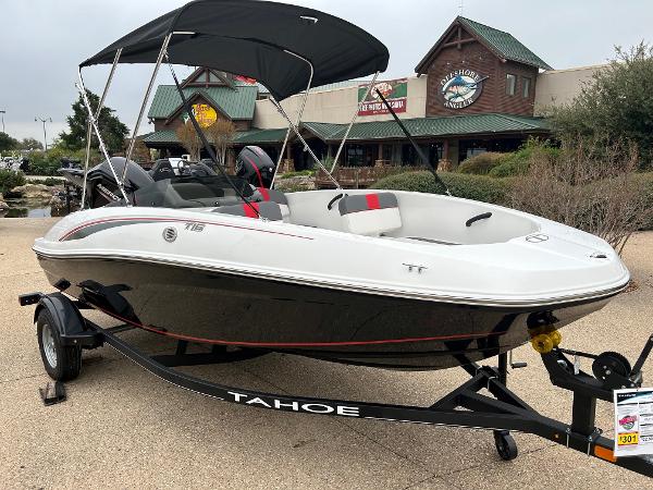 Slide: The Image of 2024 Tahoe T16 boat on trailer with canopy, displayed outdoors. - 5
