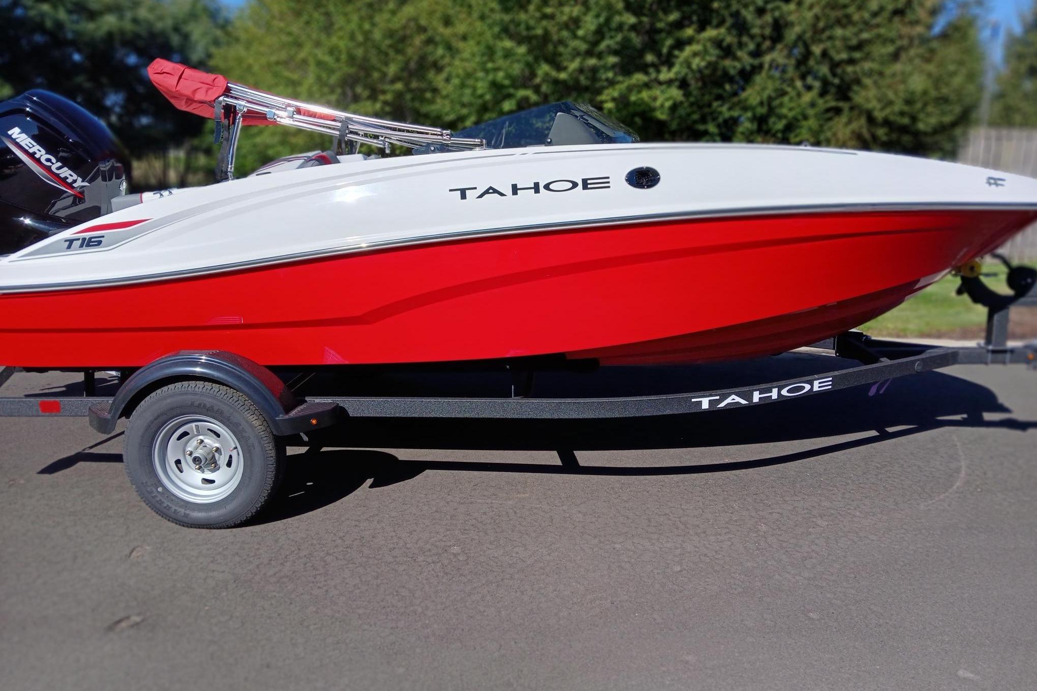 Slide: The Image of 2026 Tahoe T16 boat with red and white design on a trailer. - 0