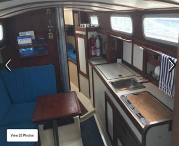 Slide: The Image of Interior of a 1974 Tartan 30 sailboat with kitchen and seating area. - 9