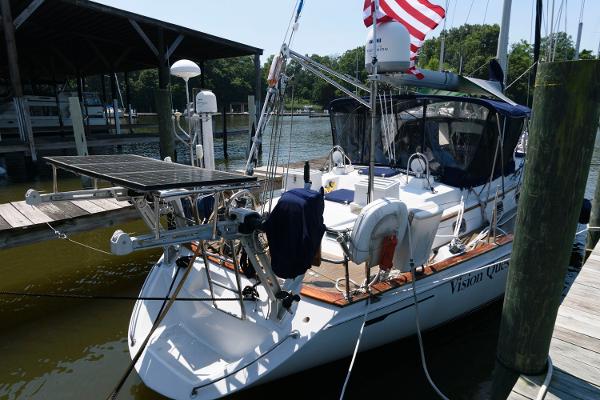Slide: The Image of 1988 Tayana 52 sailboat docked with solar panels and American flag. - 10