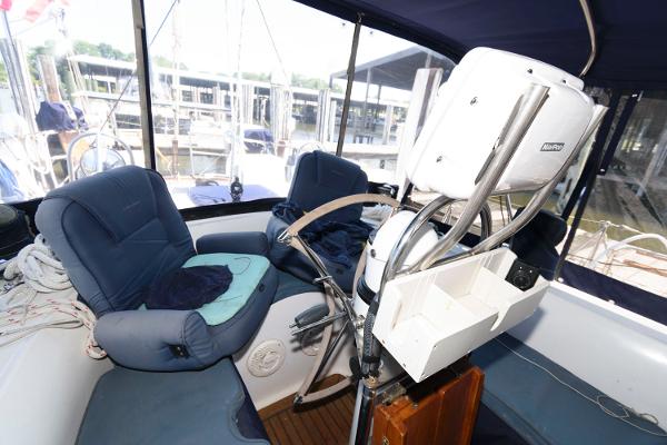 Slide: The Image of Cockpit of 1988 Tayana 52 sailboat with blue seating and navigation equipment. - 13