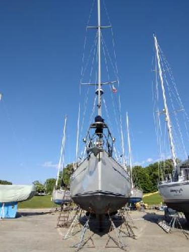 Slide: The Image of 1988 Tayana 52 sailboat on dry dock under clear blue sky. - 21