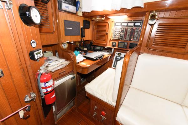 Slide: The Image of Navigation station inside 1988 Tayana 52 sailboat with wooden interior and navigation equipment. - 25
