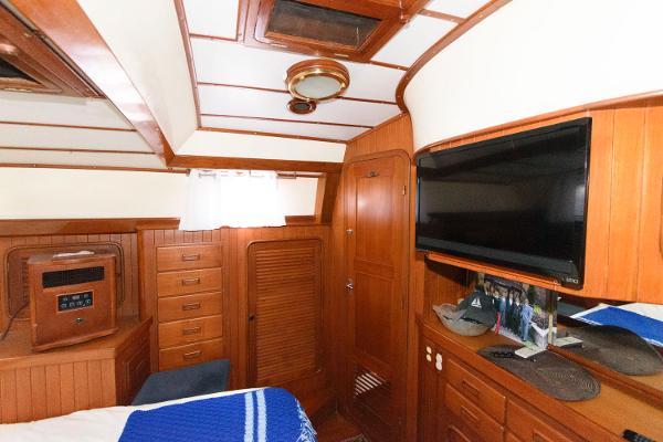Slide: The Image of Interior cabin of 1988 Tayana 52 yacht with wood paneling and TV. - 28