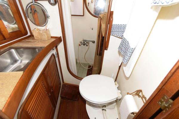 Slide: The Image of 1988 Tayana 52 yacht bathroom with sink, toilet, and shower. - 29