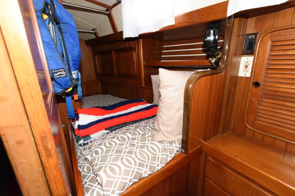 Slide: The Image of Cozy cabin bed in 1988 Tayana 52 sailboat with wooden interior. - 30
