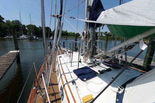 Slide: The Image of 1988 Tayana 52 sailboat docked at a marina. - 4