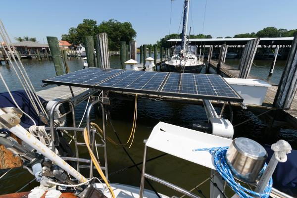 Slide: The Image of Tayana 52 sailboat with solar panels docked at a marina, 1988 model. - 6