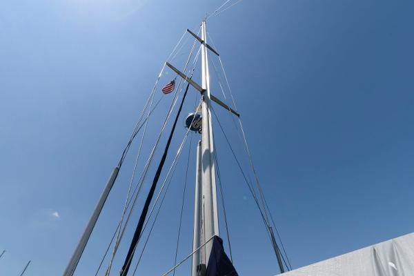 Slide: The Image of Mast of 1988 Tayana 52 sailboat against clear blue sky. - 9