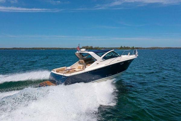 Slide: The Image of 2012 Tiara Yachts 3100 Coronet cruising on open water under clear blue skies. - 0