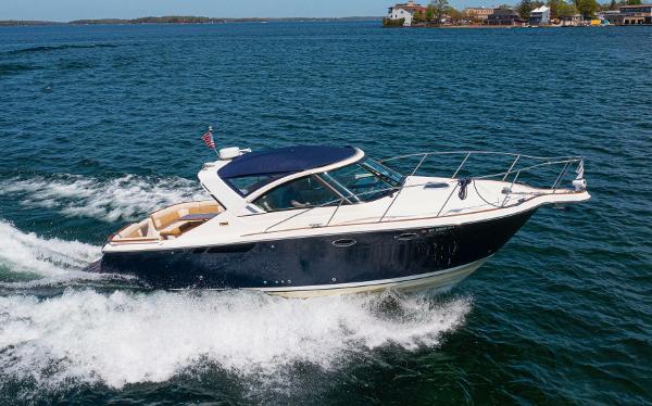 Slide: The Image of 2012 Tiara Yachts 3100 Coronet cruising on open water, showcasing sleek design and performance. - 1