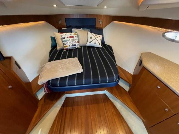 Slide: The Image of Luxurious cabin interior of 2012 Tiara Yachts 3100 Coronet with cozy bed and elegant wood finish. - 10