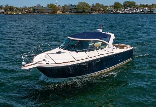 Slide: The Image of 2012 Tiara Yachts 3100 Coronet cruising on a scenic lake. - 2
