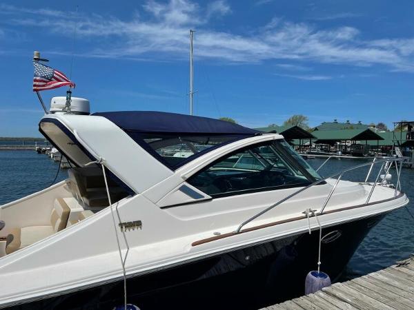 Slide: The Image of 2012 Tiara Yachts 3100 Coronet docked, featuring sleek design and American flag. - 20