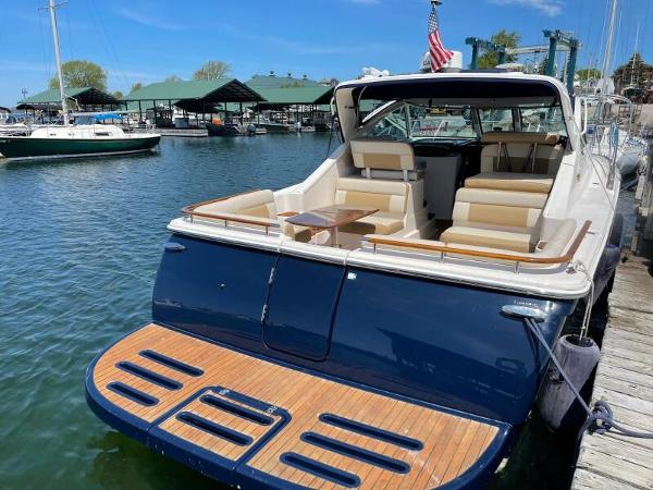 Slide: The Image of 2012 Tiara Yachts 3100 Coronet docked, featuring spacious seating and elegant design. - 3