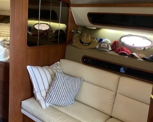 Slide: The Image of Interior of 1989 Tiara Yachts 3300 Open with white leather seating and decorative pillows. - 10