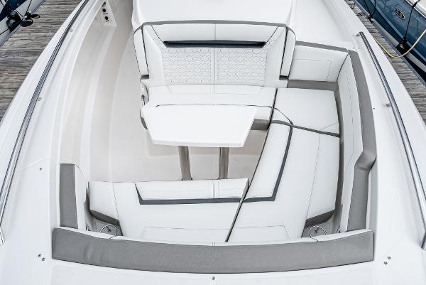 Slide: The Image of 2024 Tiara Yachts 34LS boat interior with white and gray seating and table. - 10