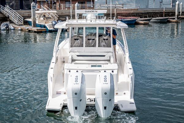 Slide: The Image of 2024 Tiara Yachts 34LS with twin 400 V8 engines docked in a marina. - 18