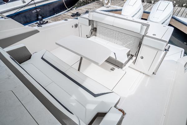 Slide: The Image of 2024 Tiara Yachts 34LS boat interior with white seating and table. - 21