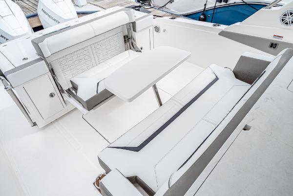 Slide: The Image of 2024 Tiara Yachts 34LS interior seating area with table and white upholstery. - 22