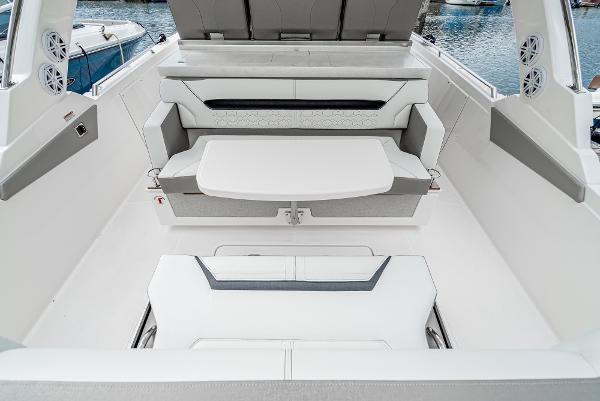 Slide: The Image of 2024 Tiara Yachts 34LS interior seating area with table, docked at marina. - 27