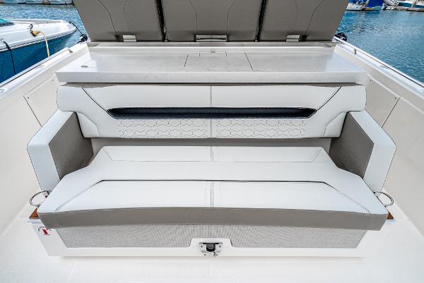 Slide: The Image of 2024 Tiara Yachts 34LS luxury boat seating area with white and gray upholstery. - 31