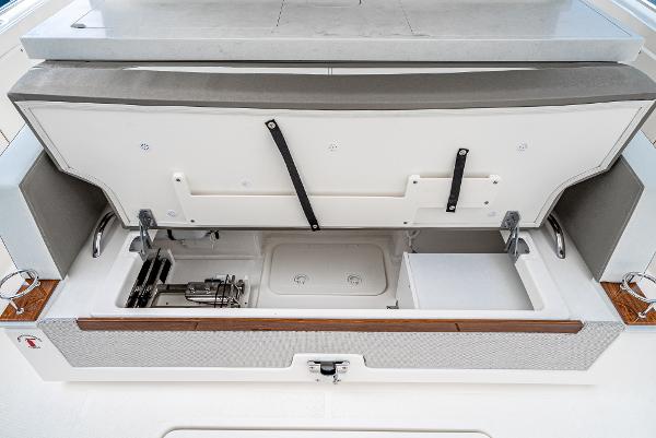 Slide: The Image of 2024 Tiara Yachts 34LS storage compartment with open lid, showcasing organized interior. - 32