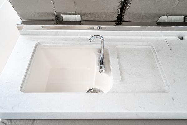 Slide: The Image of 2024 Tiara Yachts 34LS sink with modern faucet and sleek countertop. - 34