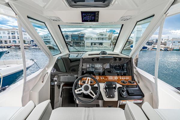 Slide: The Image of 2024 Tiara Yachts 34LS helm station with modern controls and waterfront view. - 37