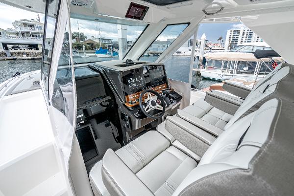 Slide: The Image of 2024 Tiara Yachts 34LS helm station with luxurious seating and advanced navigation system. - 38