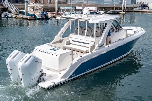 Slide: The Image of 2024 Tiara Yachts 34LS with twin Mercury outboard engines docked in marina. - 4