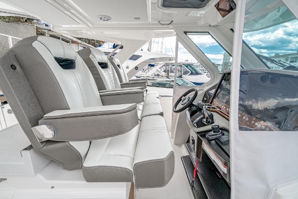 Slide: The Image of 2024 Tiara Yachts 34LS interior cockpit with luxurious seating and advanced helm controls. - 41