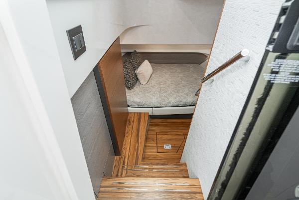 Slide: The Image of Interior cabin of 2024 Tiara Yachts 34LS with wooden steps and cozy bed. - 48