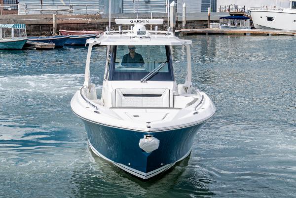 Slide: The Image of 2024 Tiara Yachts 34LS boat cruising in a marina. - 5