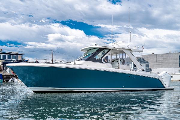 Slide: The Image of 2024 Tiara Yachts 34LS boat on water with blue hull and white deck. - 6