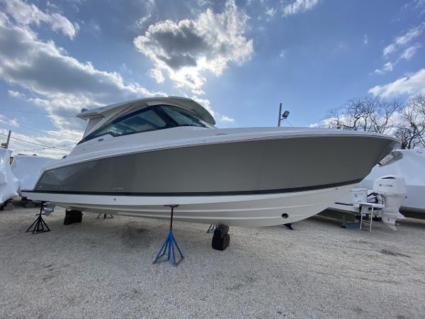 Slide: The Image of 2021 Tiara Yachts 34 LX boat on stands under a cloudy sky. - 10