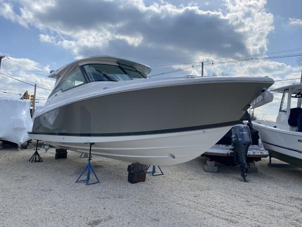 Slide: The Image of 2021 Tiara Yachts 34 LX boat on stands, under a partly cloudy sky. - 11
