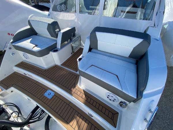 Slide: The Image of 2021 Tiara Yachts 34 LX interior with cushioned seating and teak flooring. - 15