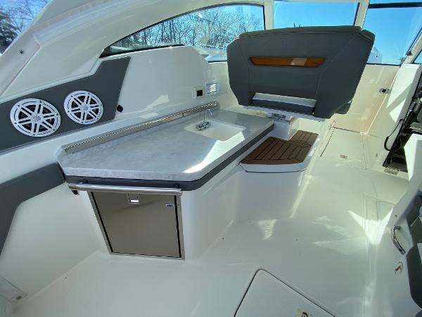 Slide: The Image of 2021 Tiara Yachts 34 LX interior with sleek seating and modern amenities. - 17