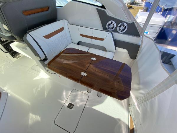 Slide: The Image of 2021 Tiara Yachts 34 LX interior with elegant seating and wooden table. - 20