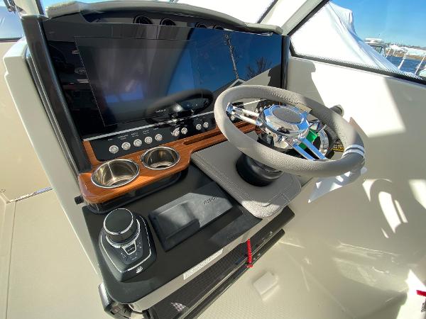 Slide: The Image of 2021 Tiara Yachts 34 LX helm with modern controls and steering wheel. - 23