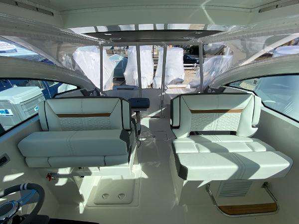 Slide: The Image of Interior of 2021 Tiara Yachts 34 LX, featuring modern seating and sleek design. - 25