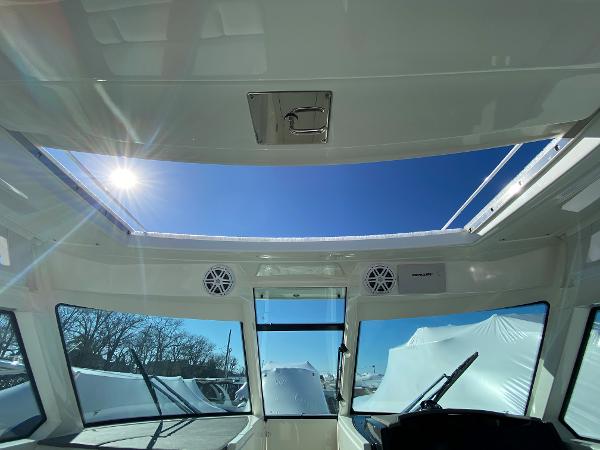 Slide: The Image of 2021 Tiara Yachts 34 LX interior with sunroof, showcasing clear blue sky. - 26