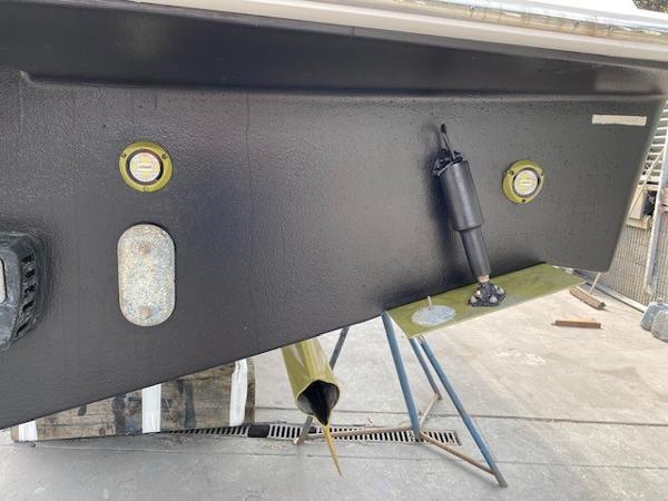 Slide: The Image of 2020 Tiara Yachts 39 Coupe hull detail with fittings and support stands. - 12